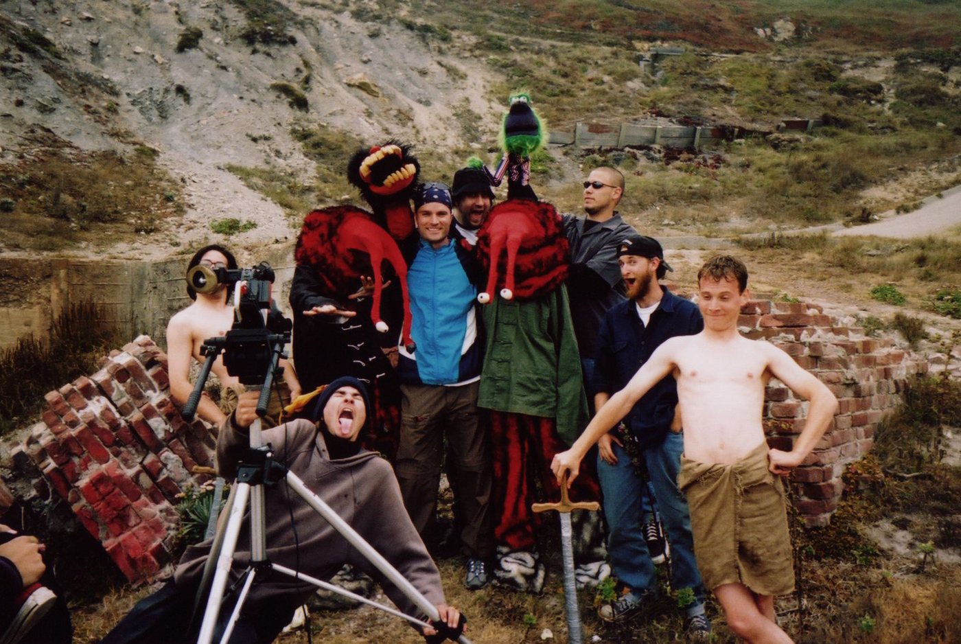 The cast and crew posing on location with the camera, puppets, and props.