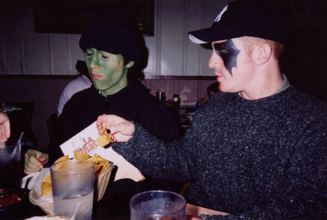 Two cast members in villain makeup eating dinner.