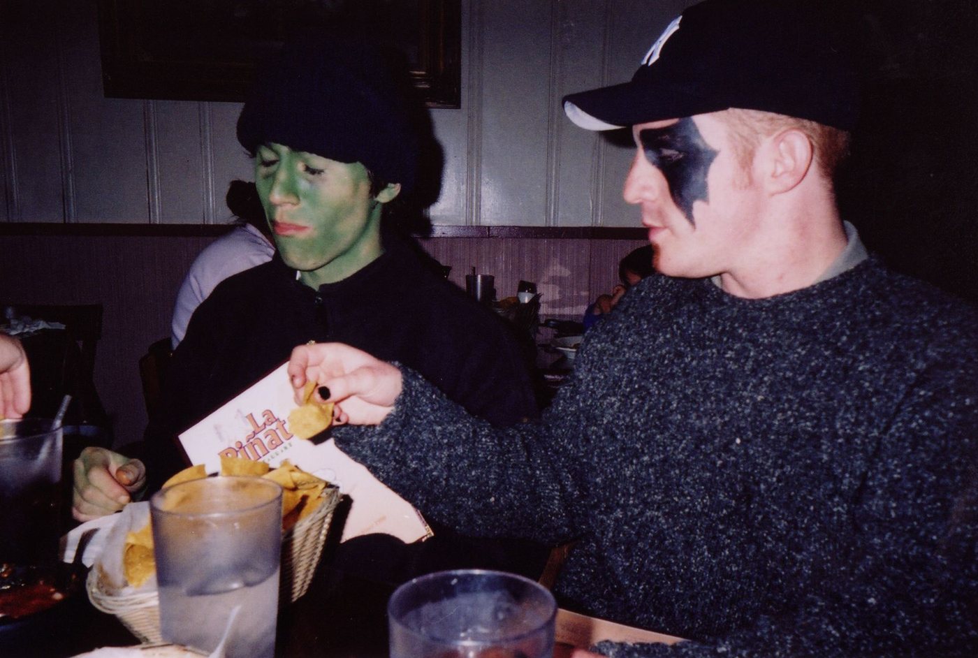 Two cast members in villain makeup eating dinner.