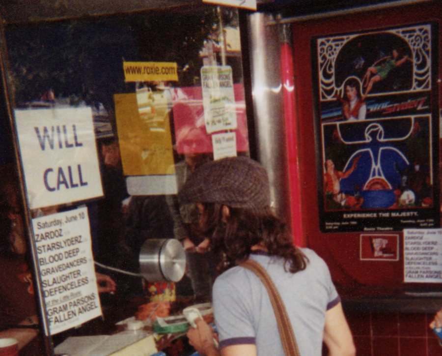 The Roxie box office window, with a lineup card listing Zardoz and Starslyderz, and the painted Starslyderz poster on the wall.